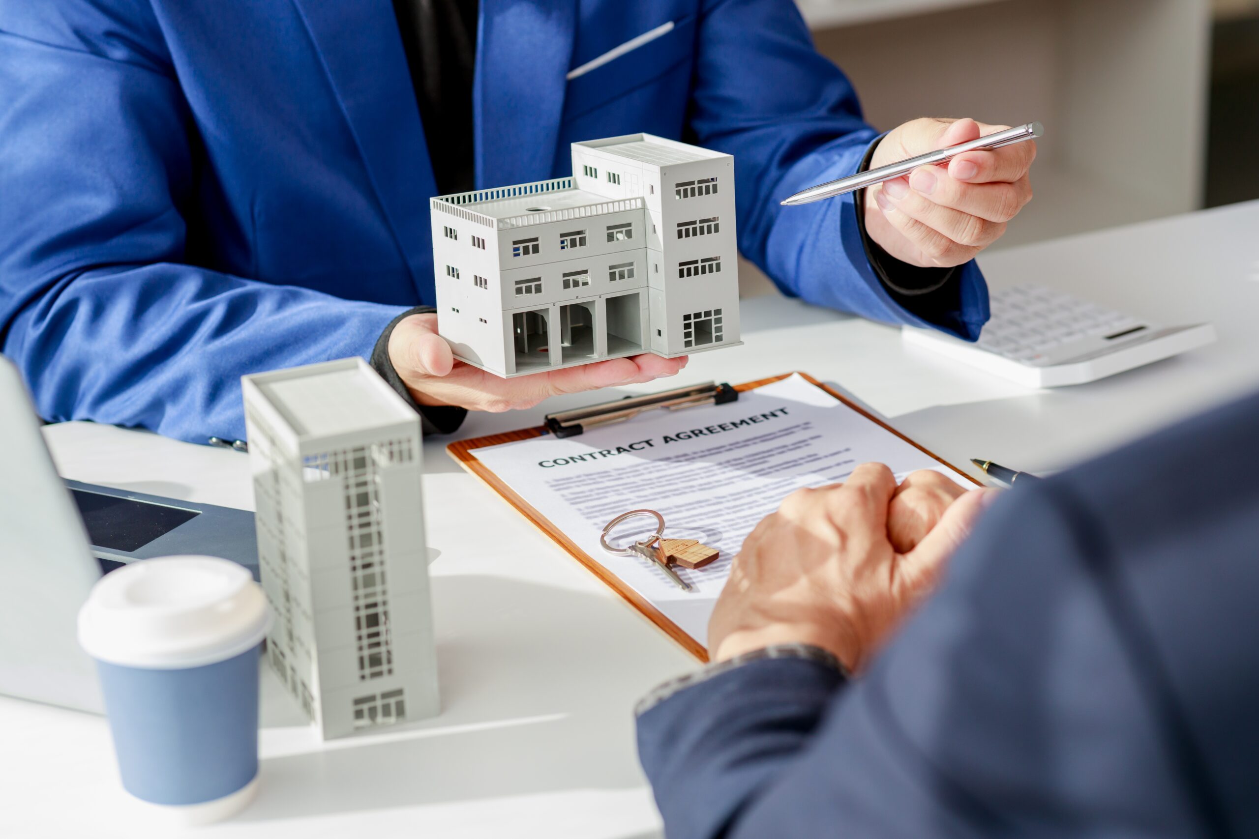 Real estate agent presenting condo model and contract agreement explaining new 7 day cancellation period under 2025 condo rider